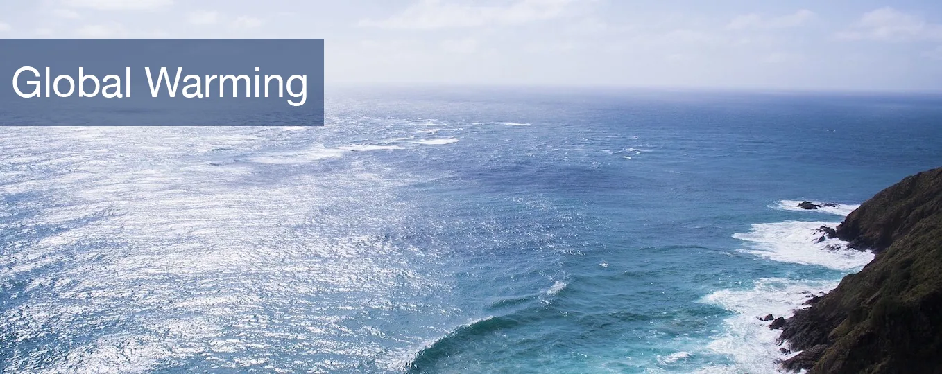 Coastal ocean view with rocky shoreline and text overlay reading 'Global Warming'