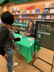Woman at book signing table with author at Barnes & Noble bookstore event