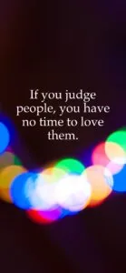 Inspirational quote text on dark background with colorful bokeh lights below